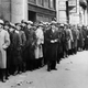 People wait outside the State Labor Bureau for federal relief jobs in New York City in November 1933. (AP Photo)